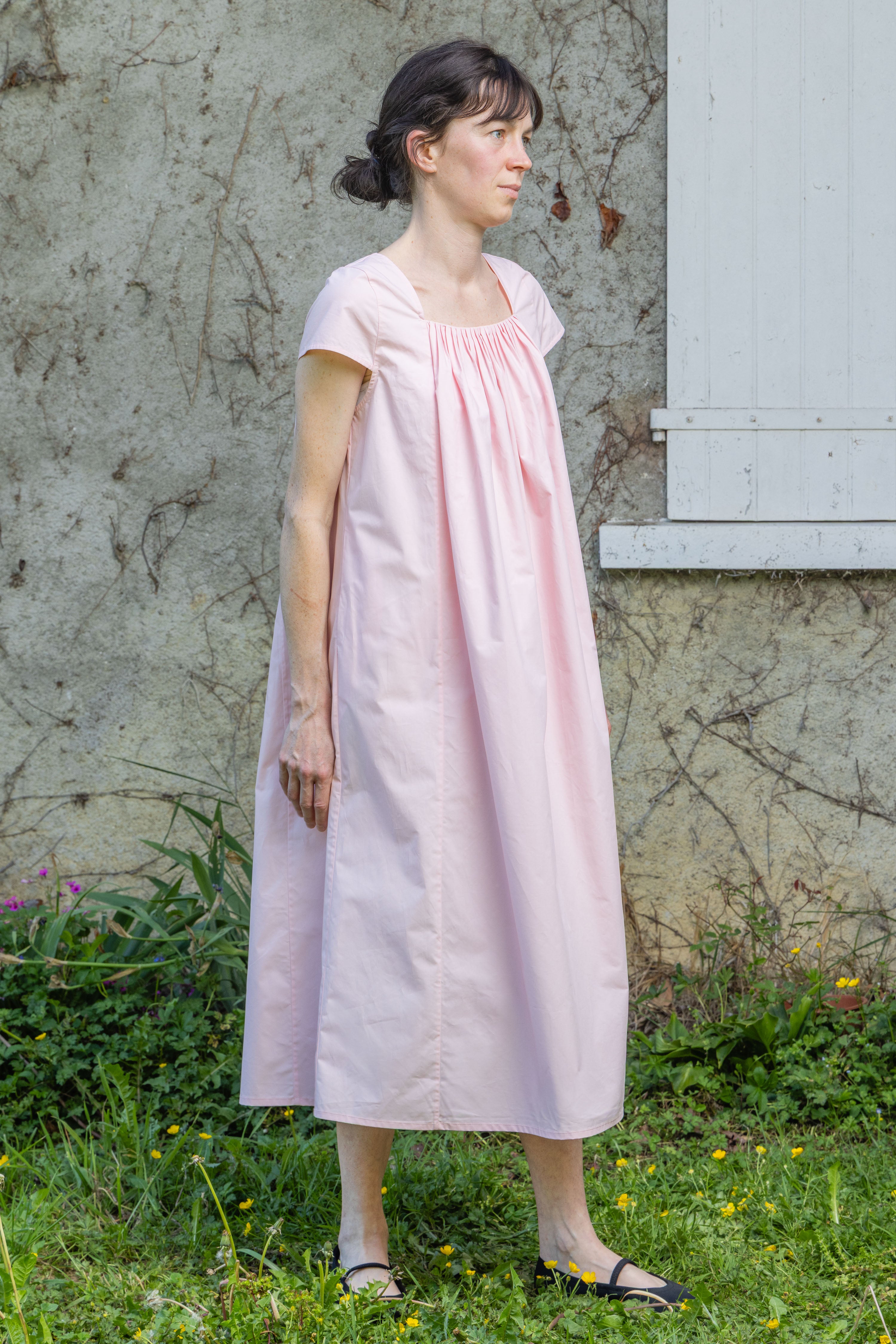 Pink Hier dress with gathered yoke and short sleeves, side view, knee-length