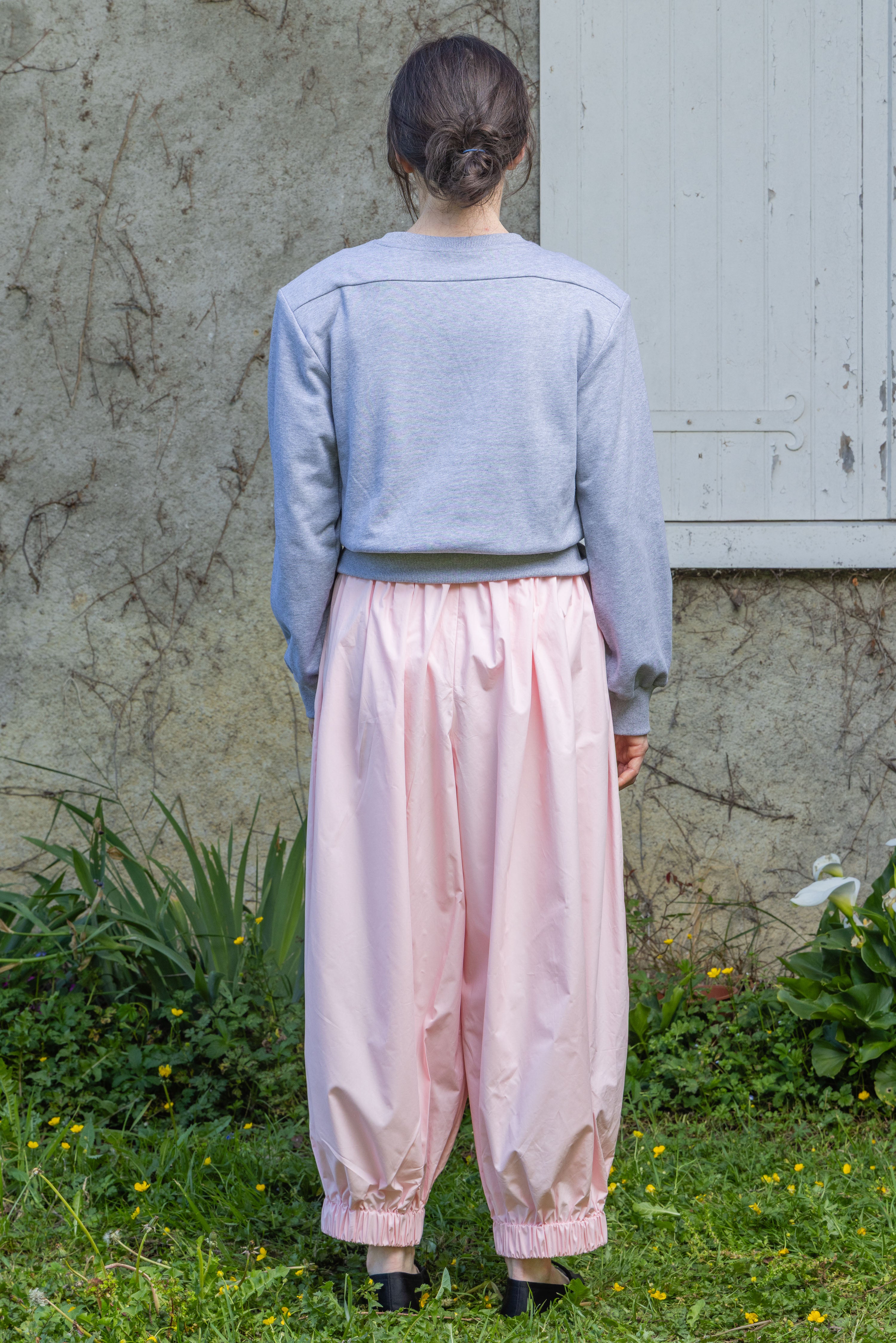 Heather grey V-neck knit top, back view, long sleeves with ribbed cuffs