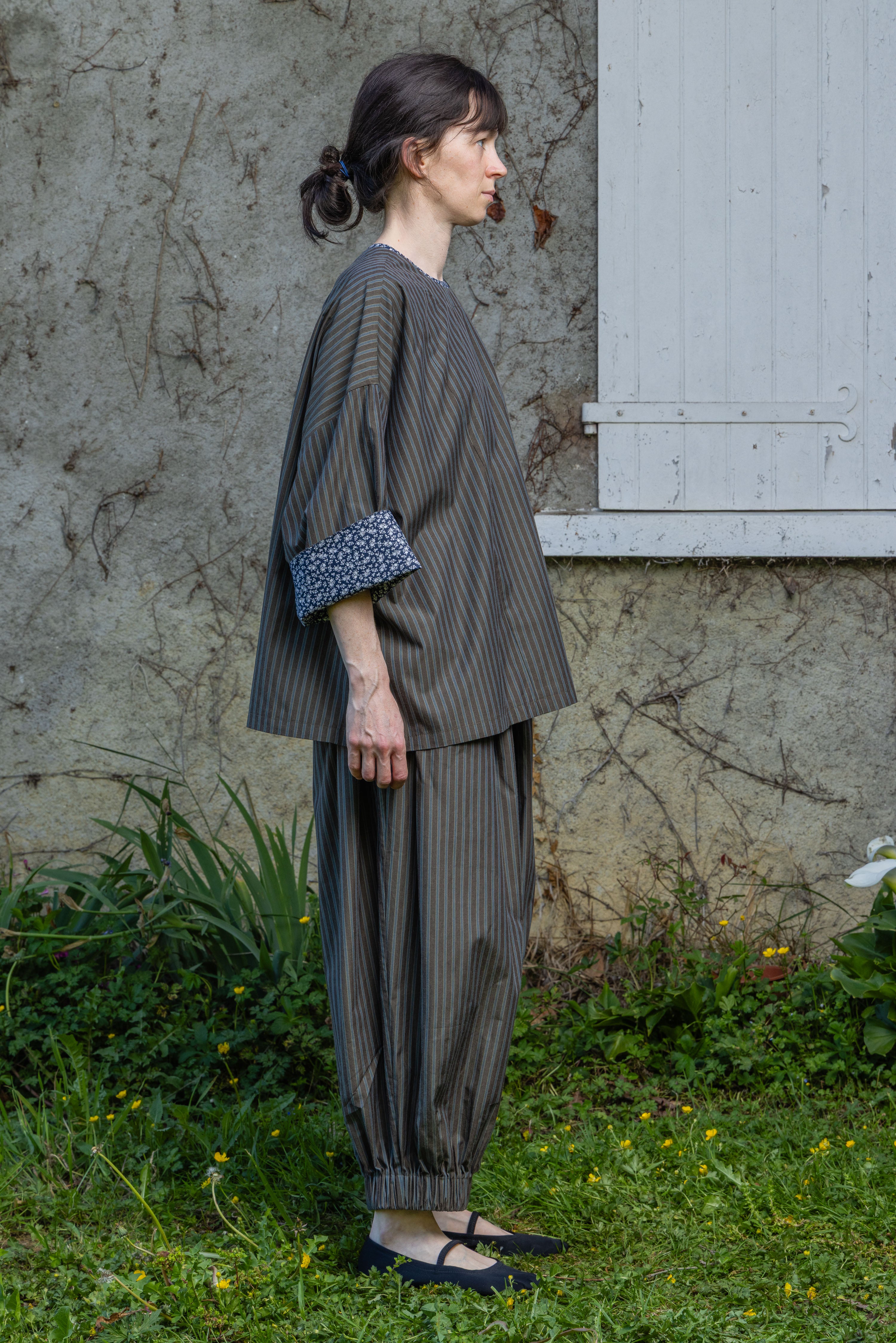 Loose striped top with patterned contrast cuffs, side view
