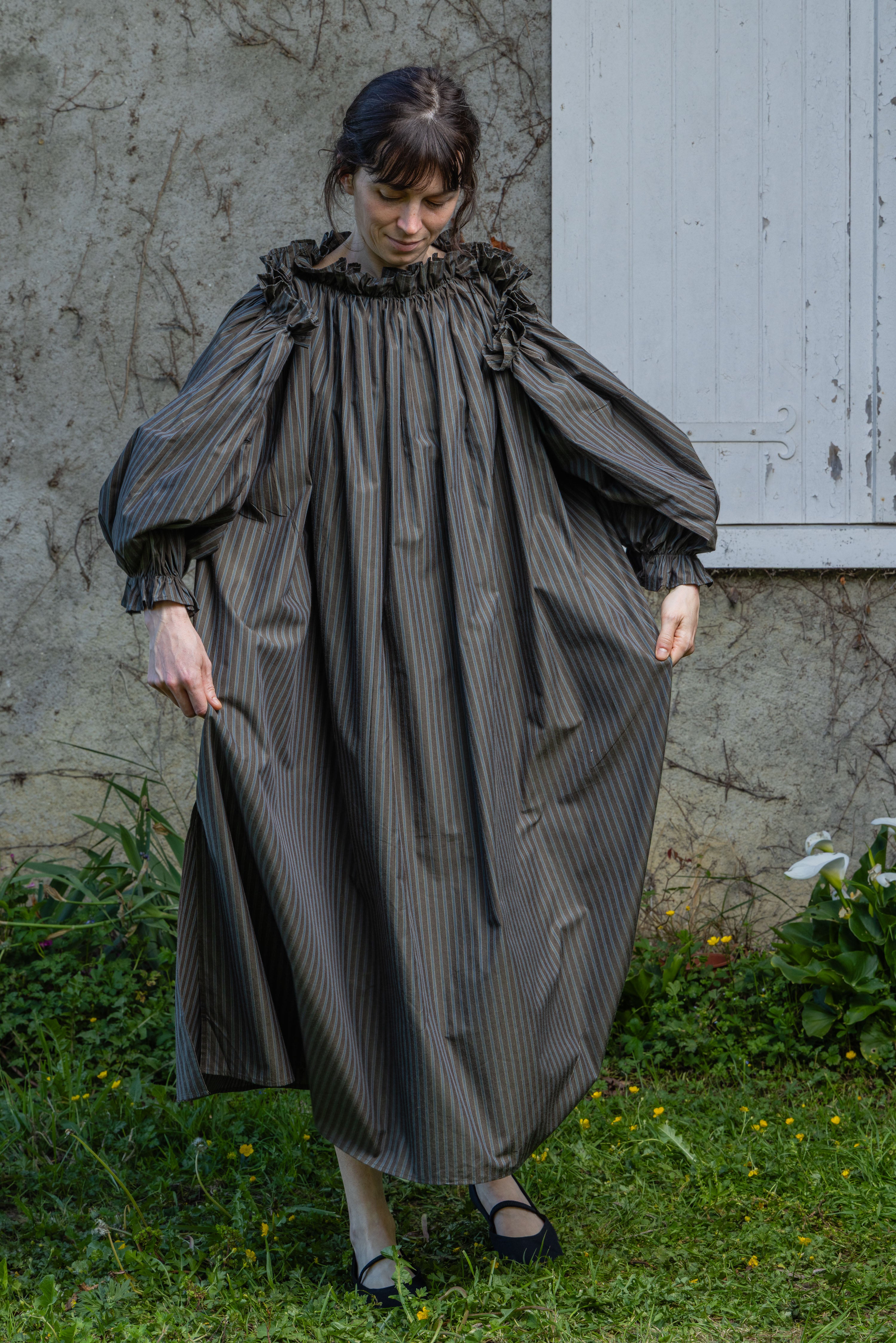 Dark olive striped midi dress with ruffled collar and oversized puff sleeves.