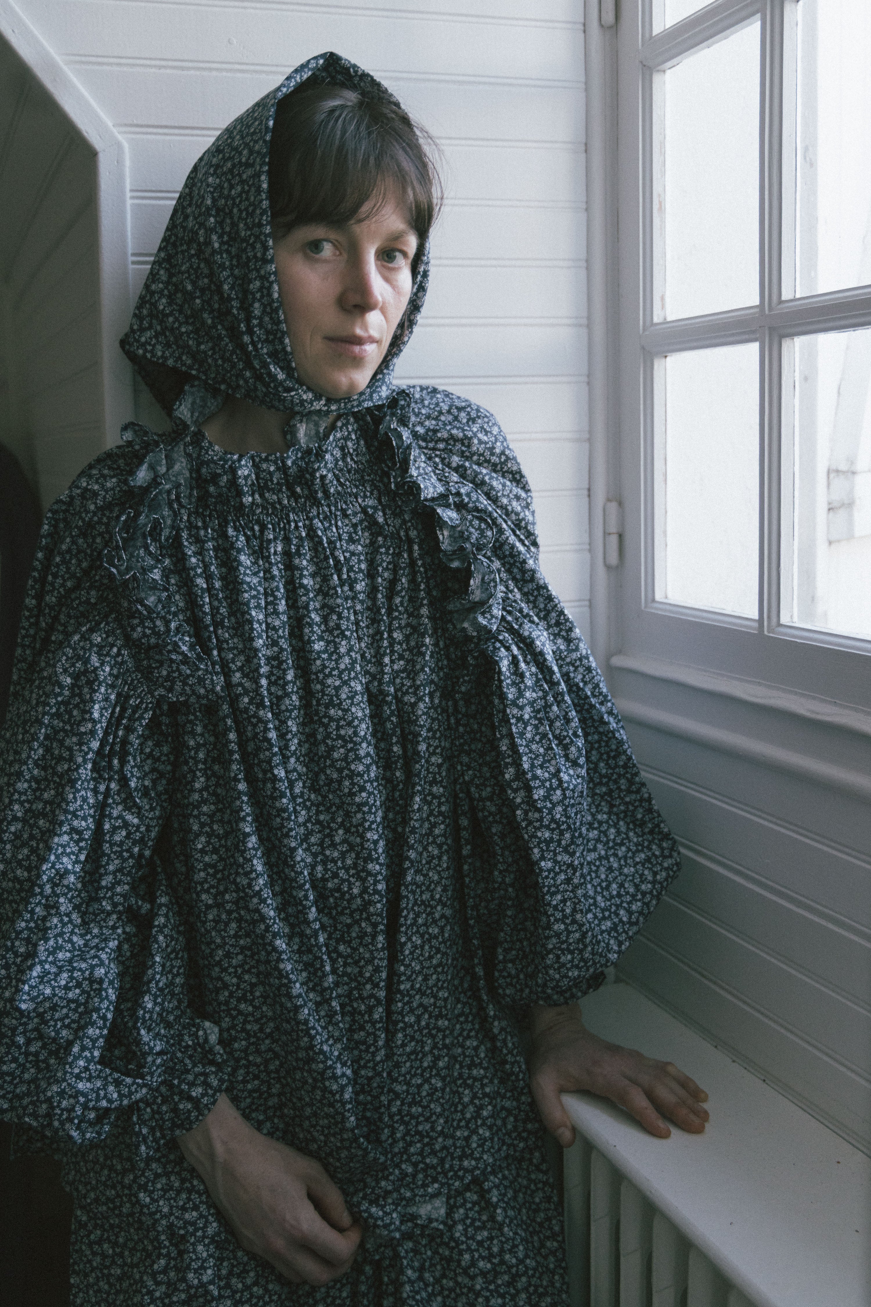 Dark patterned peasant top with gathered neckline and long puff sleeves