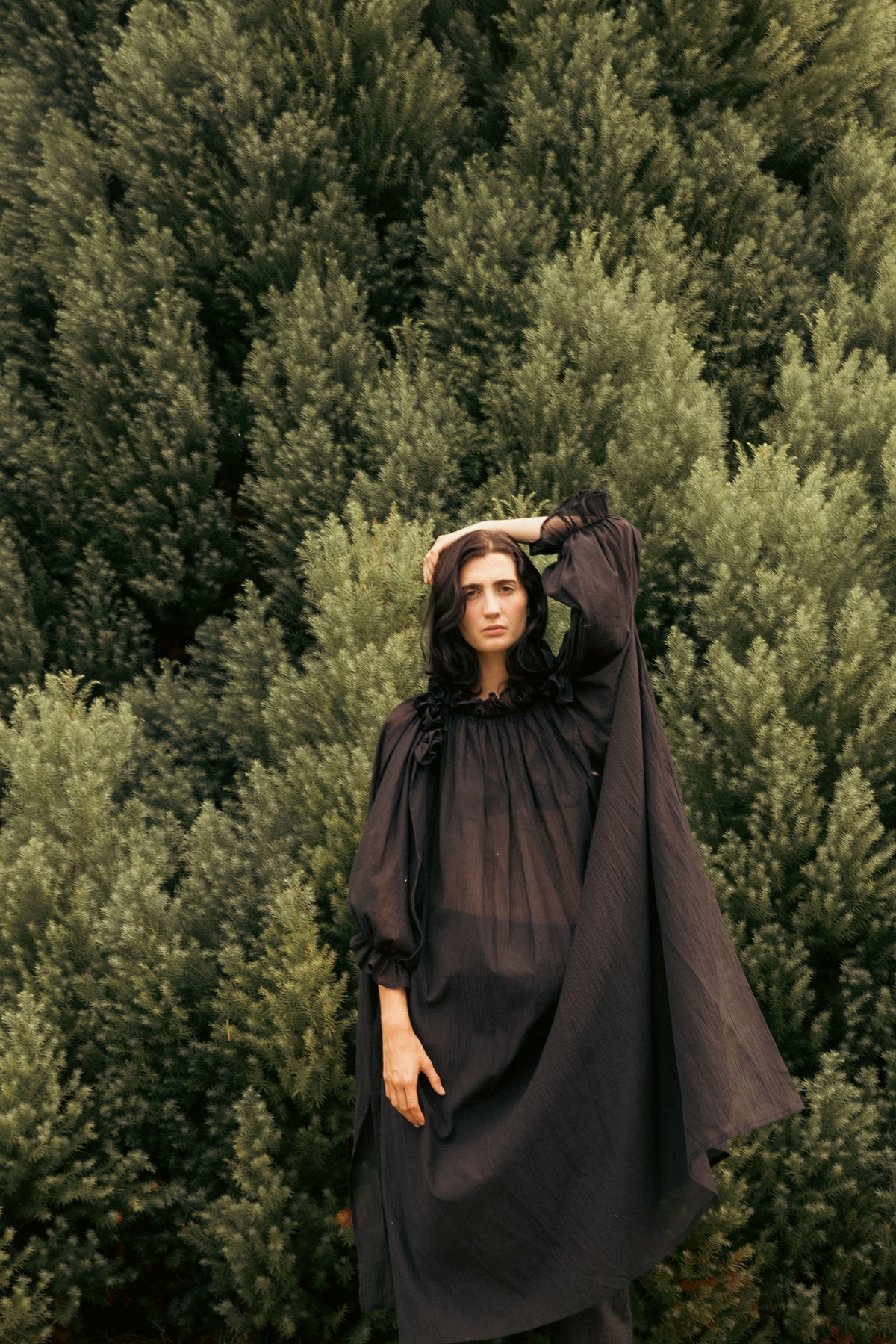 Black off-shoulder maxi dress with ruffled trim, gathered bodice, and wide skirt