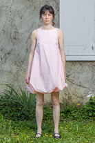 Pink bubble dress with sleeveless bodice and gathered skirt hem