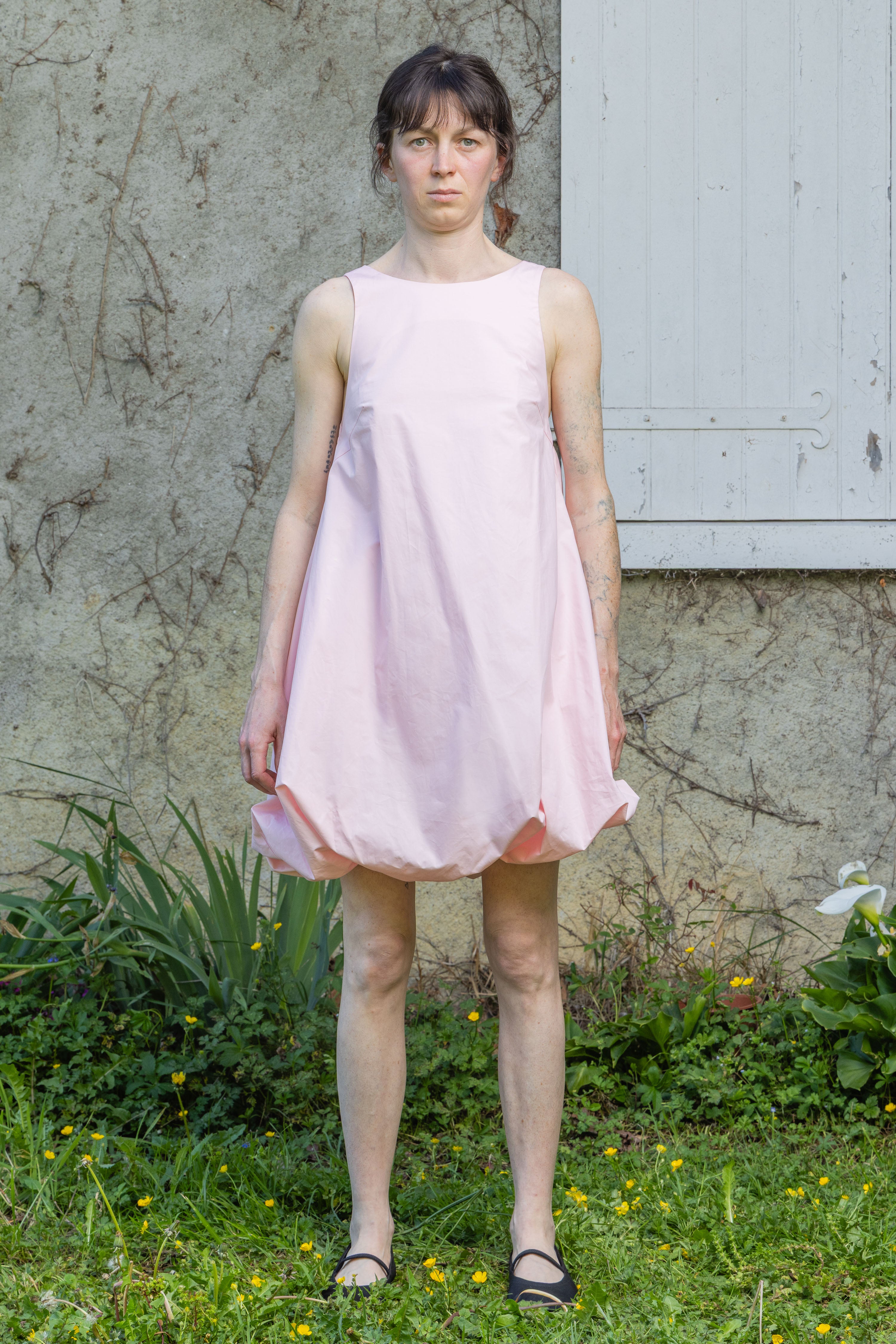 Pink bubble dress with sleeveless bodice and gathered skirt hem
