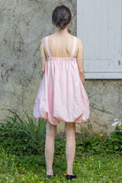 Pink bubble dress with open back and thin straps, gathered skirt hem