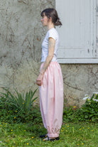 Light pink trousers with elastic waistband and gathered ankles