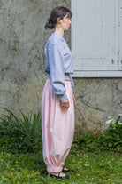 Heather grey V-neck knit top, long sleeves with ribbed cuffs, relaxed drape