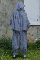 Navy floral peasant top with gathered back, cape-like sleeves, and hood