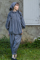 Navy floral peasant top with shoulder ruffle and long puff sleeves