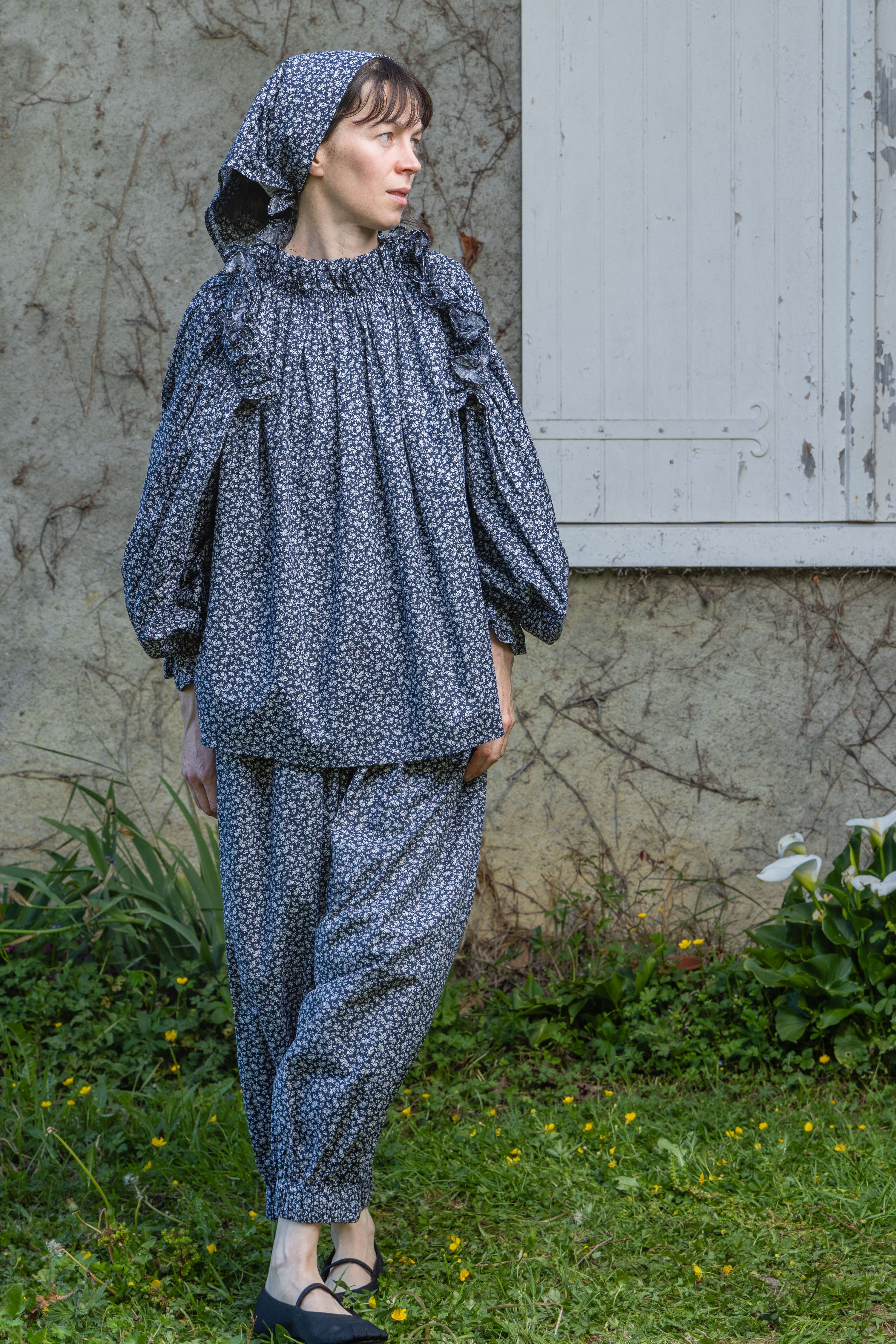Navy floral peasant top with shoulder ruffle and long puff sleeves