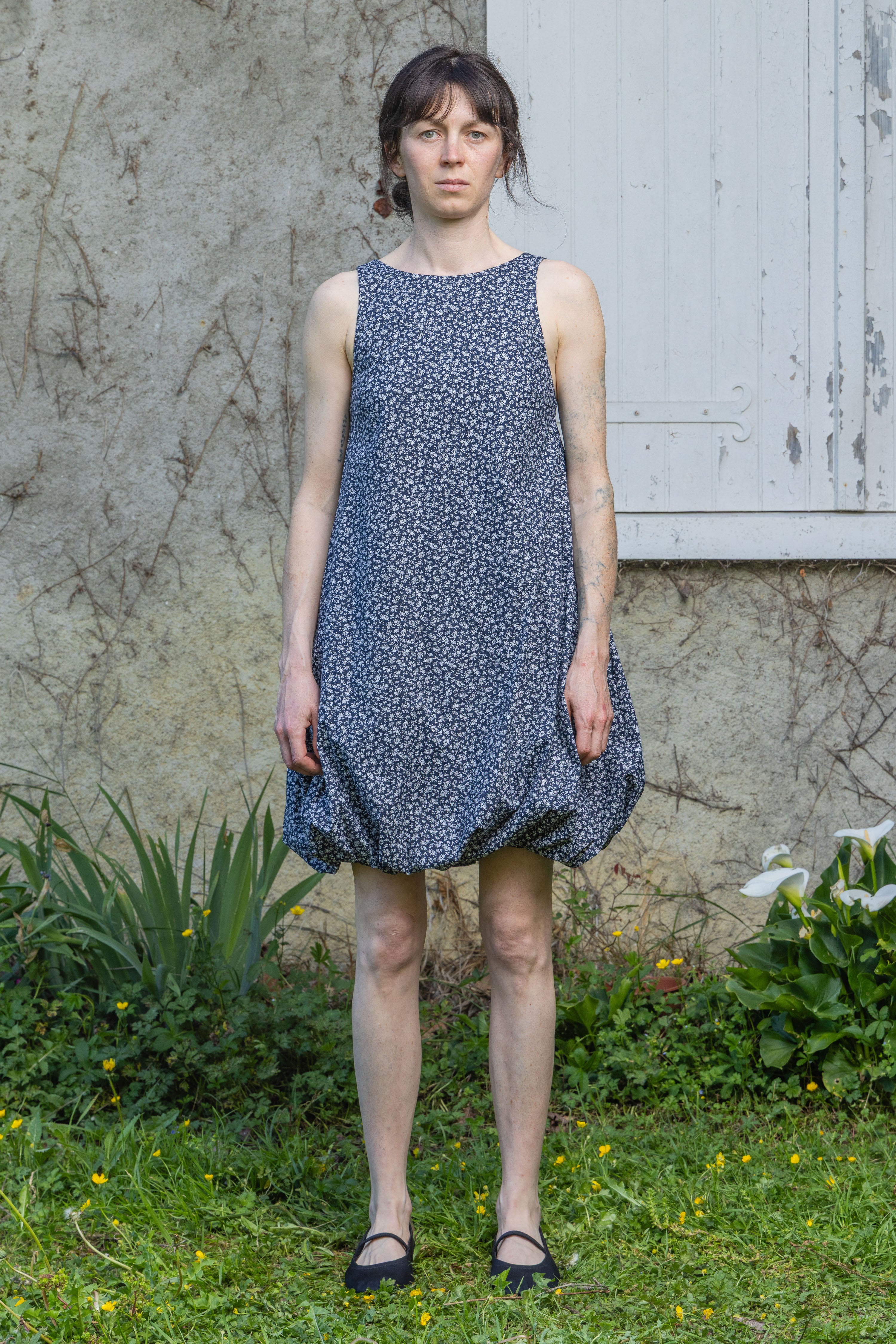 Navy floral bubble dress with sleeveless bodice and gathered skirt hem