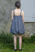 Navy floral bubble dress with spaghetti straps, gathered skirt and open back