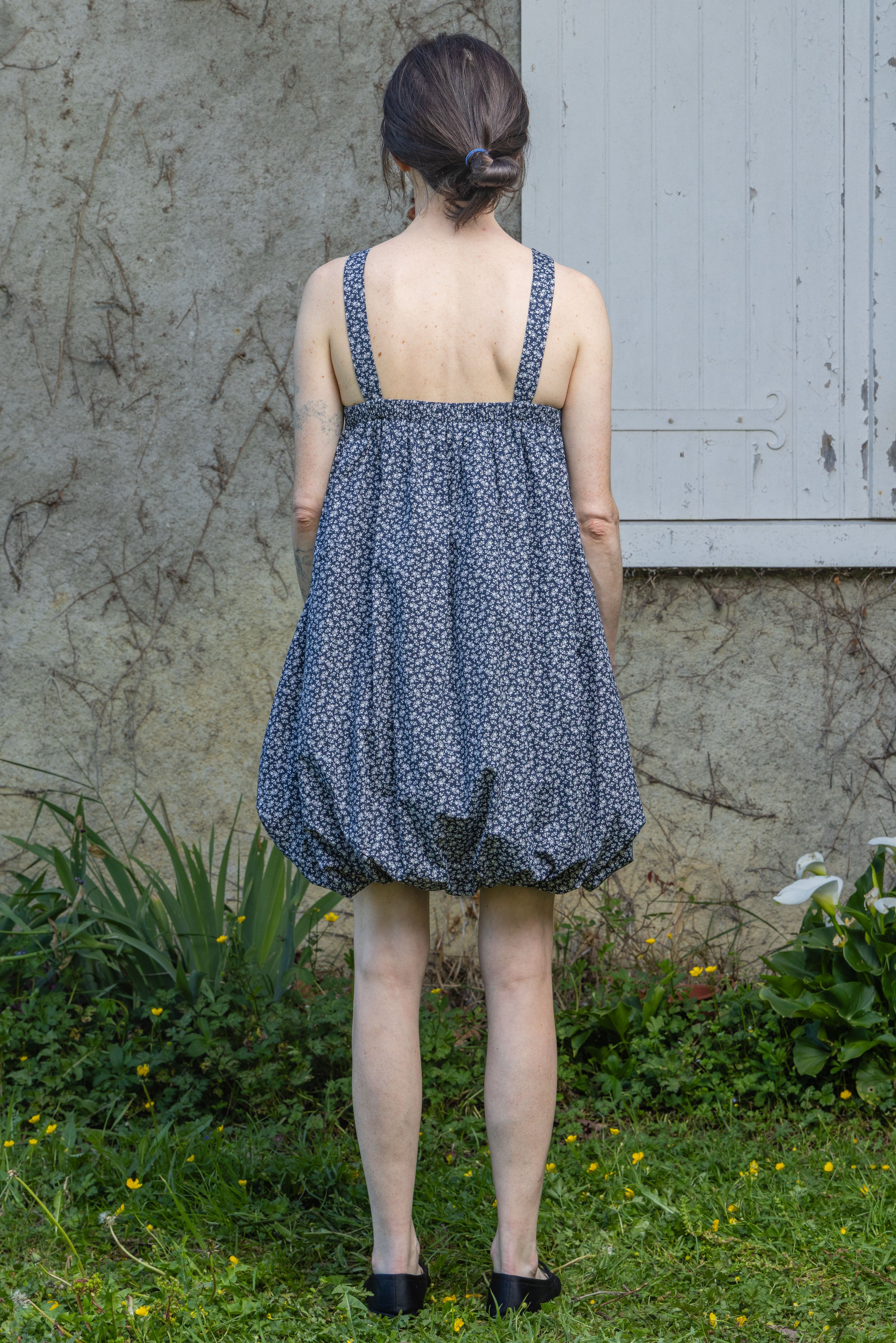Navy floral bubble dress with spaghetti straps, gathered skirt and open back