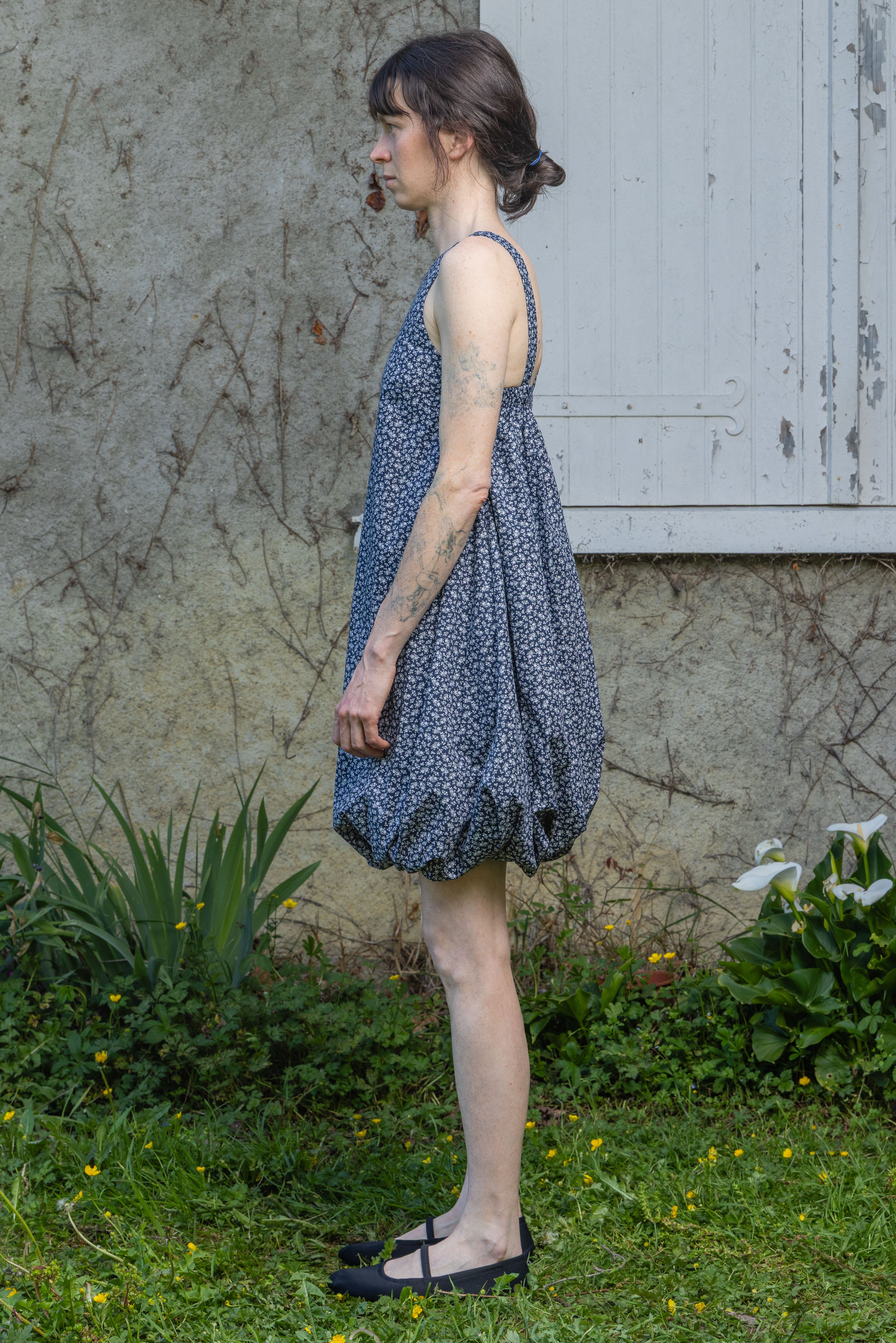 Navy floral bubble dress with thin straps and gathered skirt hem