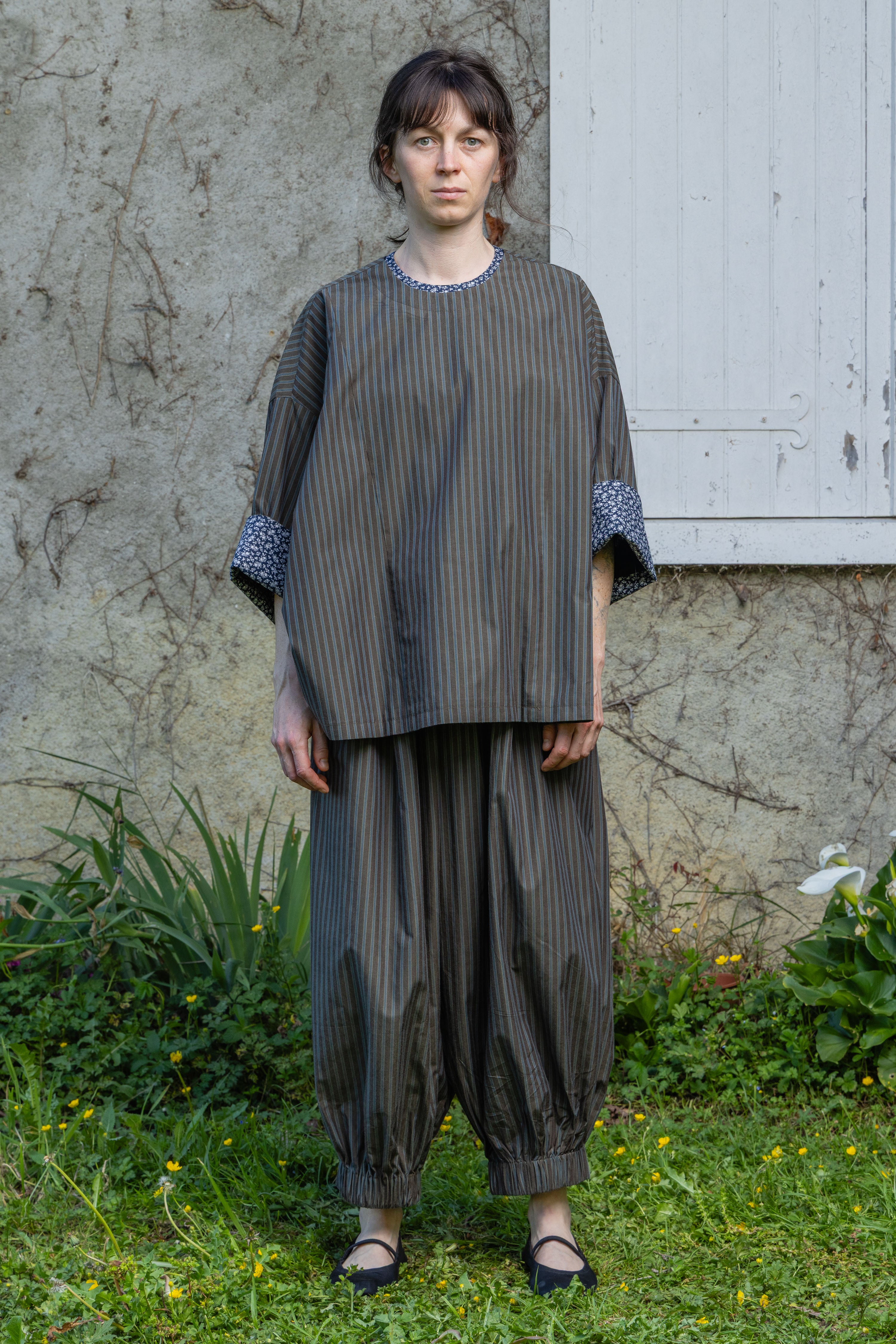 Loose striped top with round neckline and patterned contrast sleeve cuffs