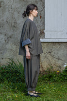 Loose striped top with patterned contrast cuffs, side view