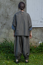 Loose striped top, back view with neck opening and patterned contrast cuffs