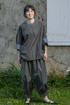 Loose striped top with round neckline and patterned contrast cuffs