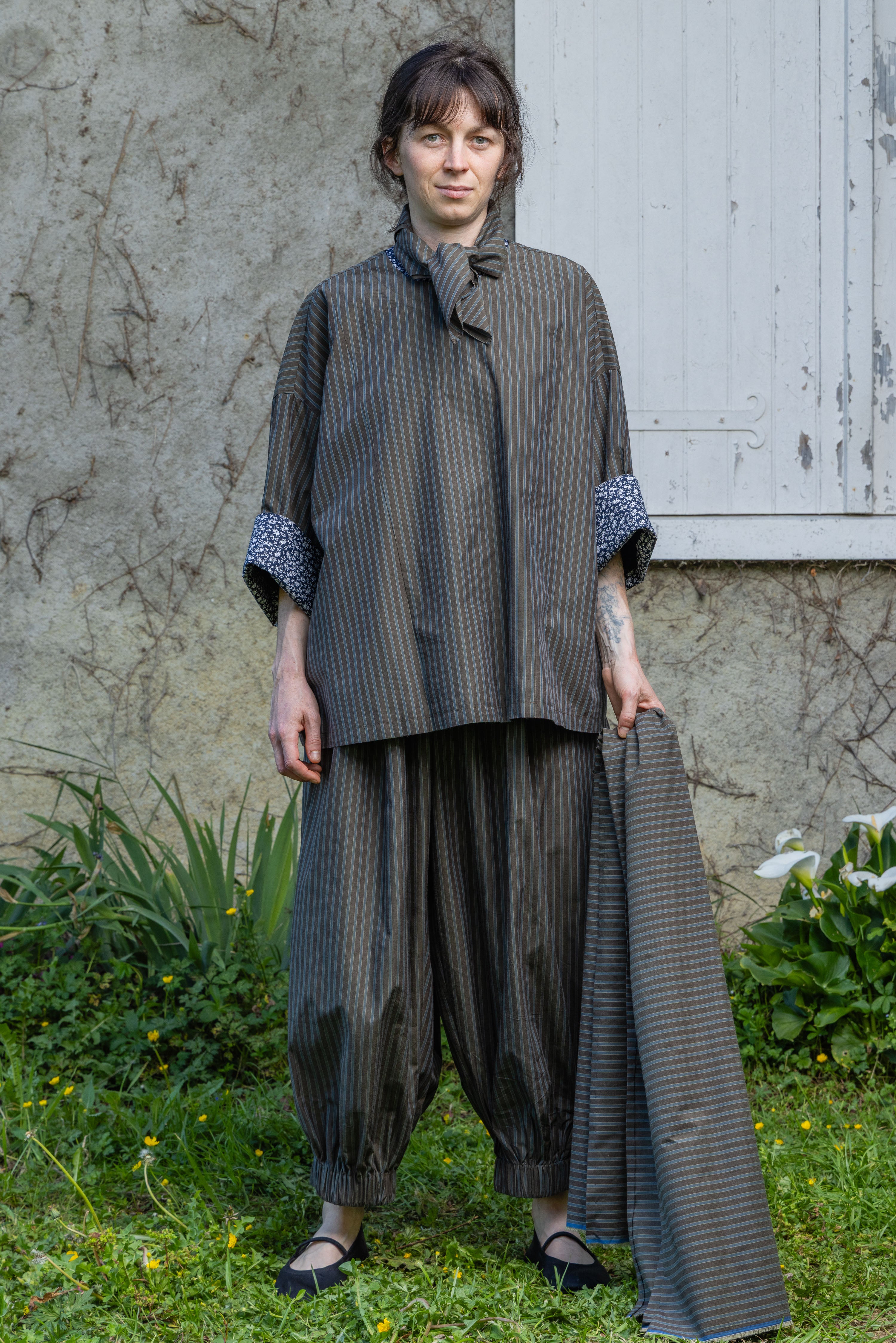 Loose striped top with neck tie at collar and patterned contrast cuffs