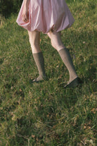 Pink bubble dress hem with gathered ruffle and cinched skirt at sides