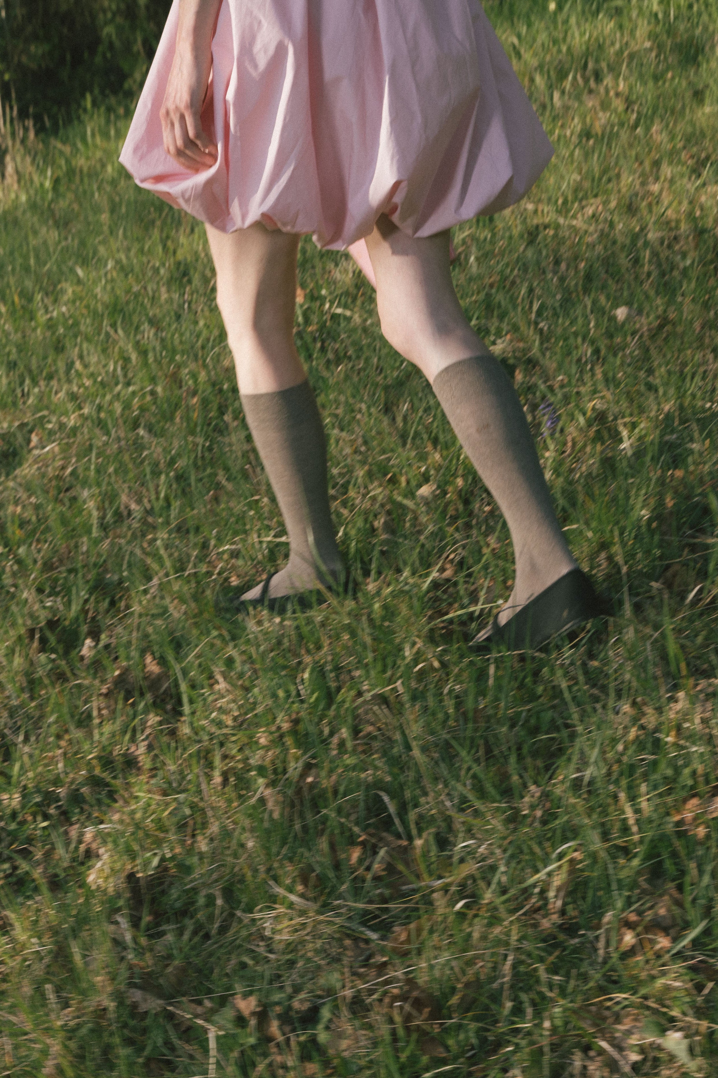 Pink bubble dress hem with gathered ruffle and cinched skirt at sides