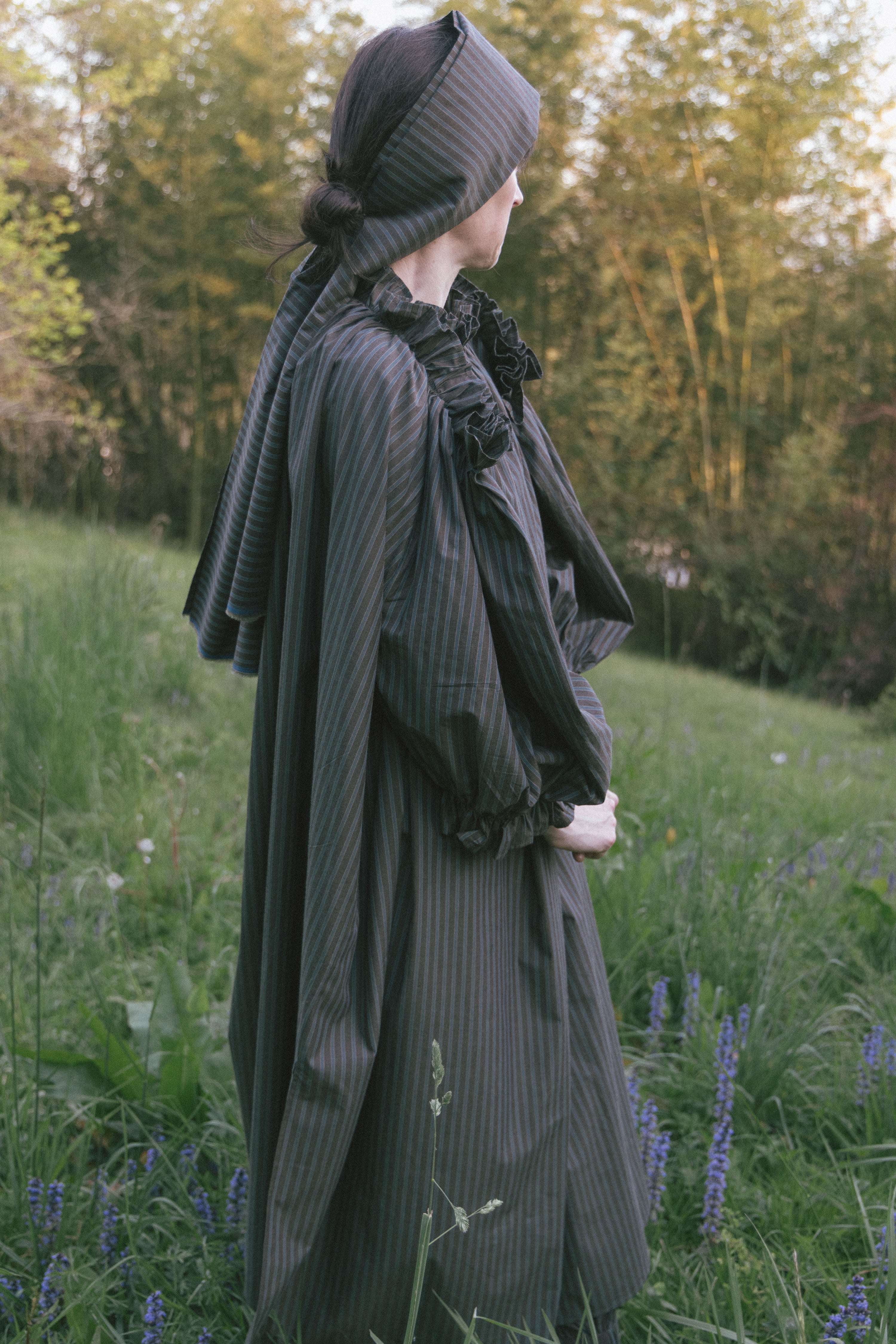 Olive striped midi dress with ruffled high neck and voluminous sleeves, back view.