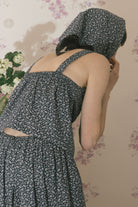 Navy floral sleeveless tank top with low back and cross-strap design