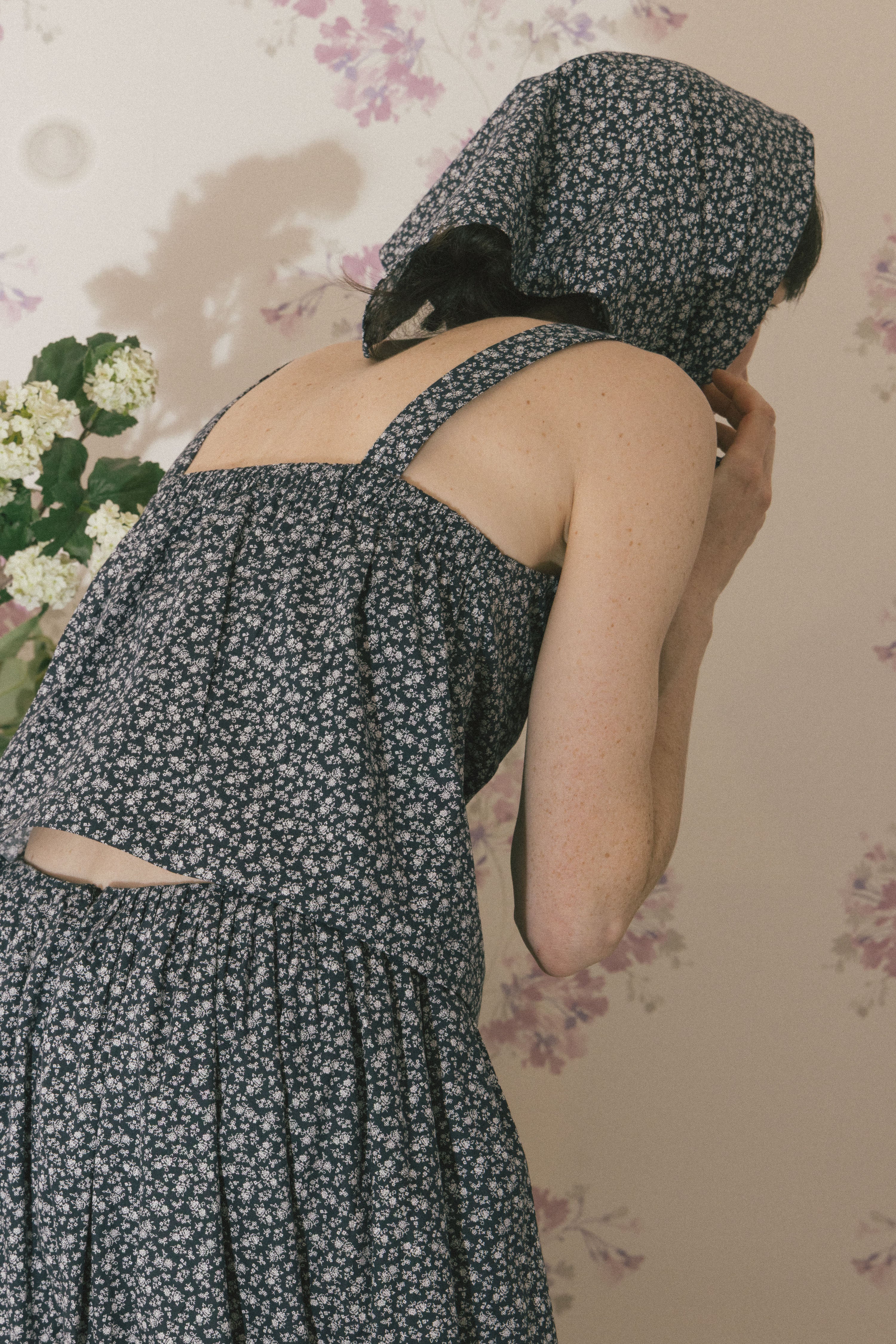 Navy floral sleeveless tank top with low back and cross-strap design