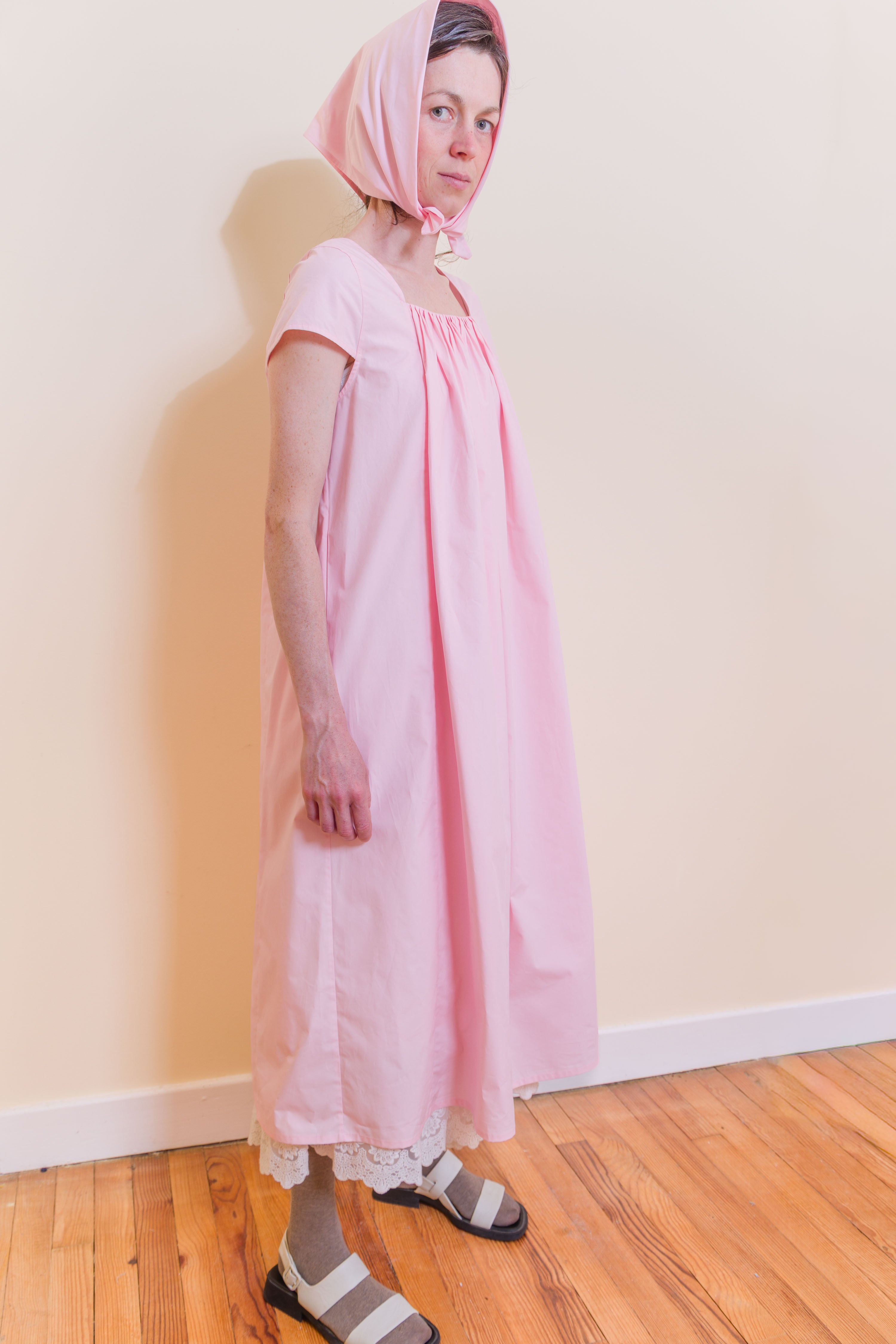 Pink Hier dress with gathered neckline, cap sleeves and knee-length skirt, side view