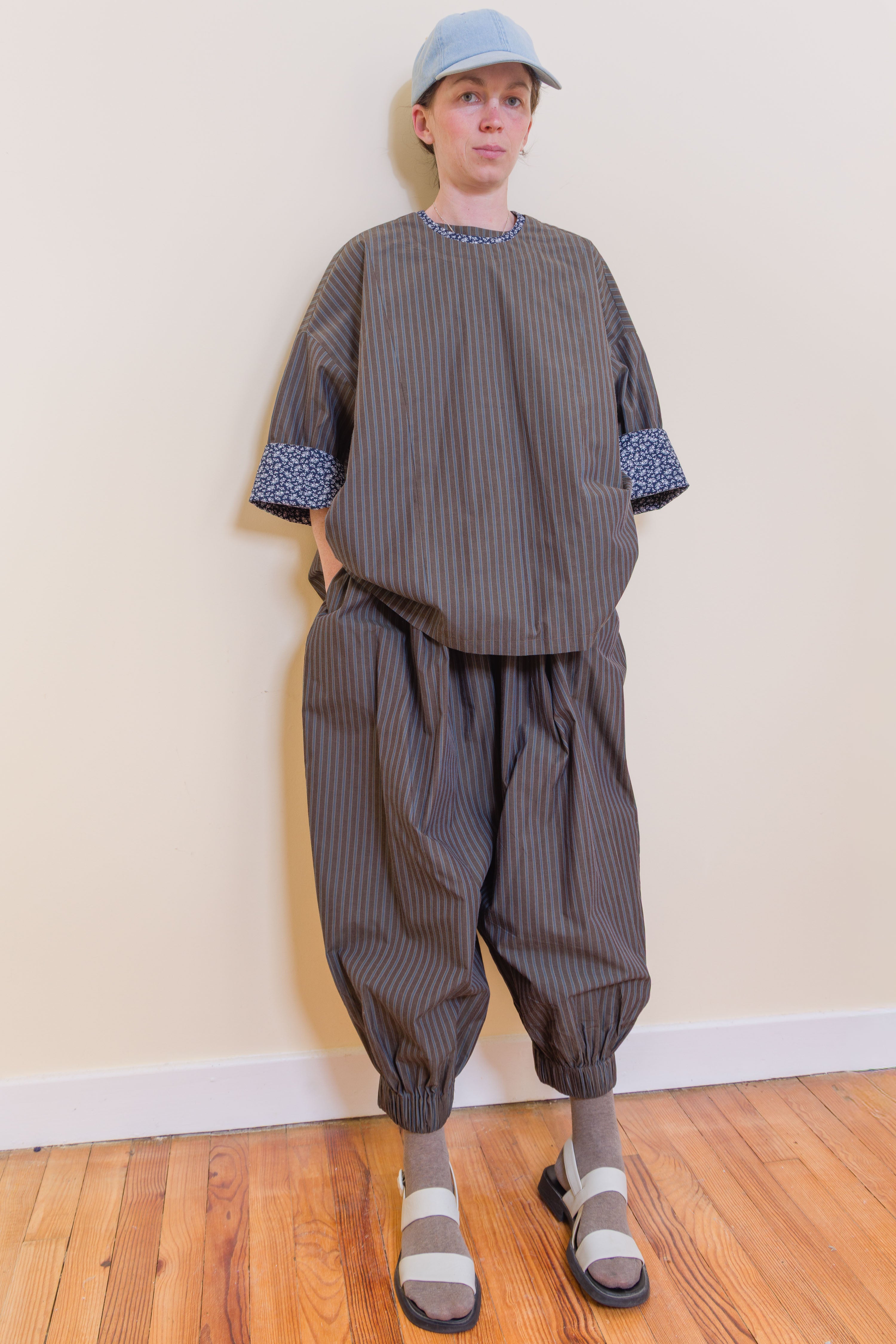 Loose striped top with round neckline and patterned contrast cuffs