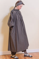 Olive striped midi dress with ruffled high collar, puff sleeves, and gathered skirt.