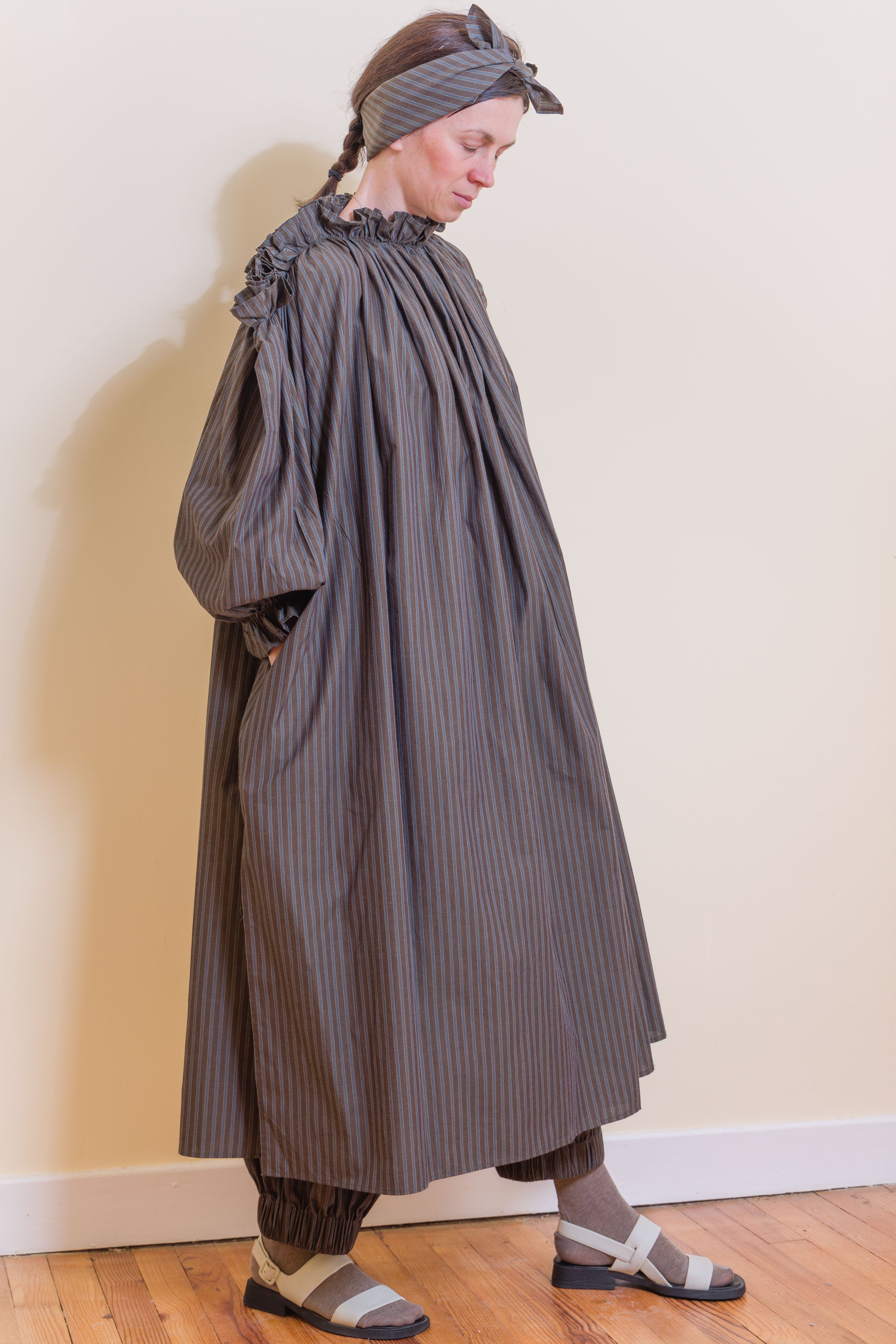 Olive striped midi dress with ruffled high collar, puff sleeves, and gathered skirt.