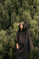 Black off-shoulder maxi dress with ruffled trim, gathered bodice, and wide skirt