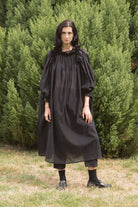 Black maxi dress with ruffled off-shoulder neckline, puff sleeves, gathered bodice